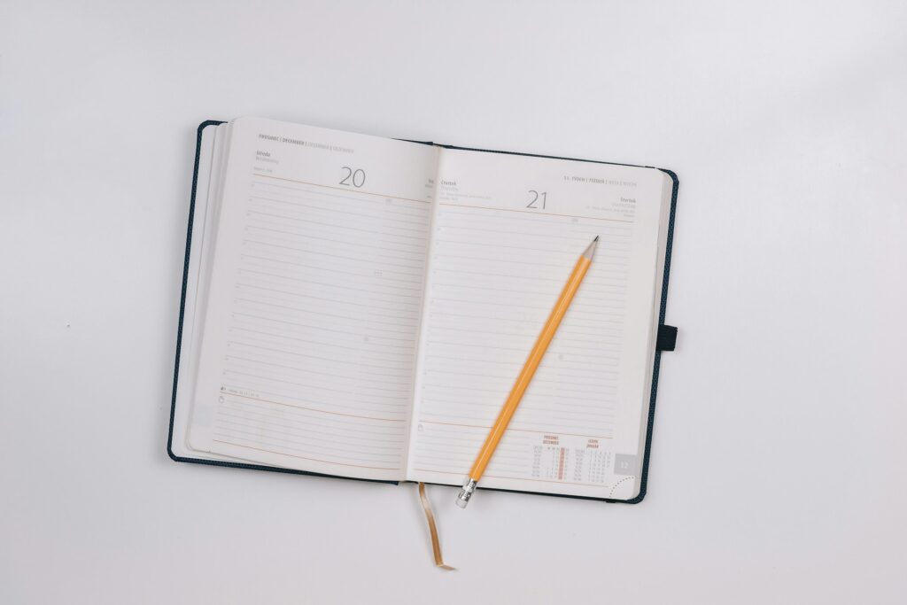 An open blank notebook with a pencil